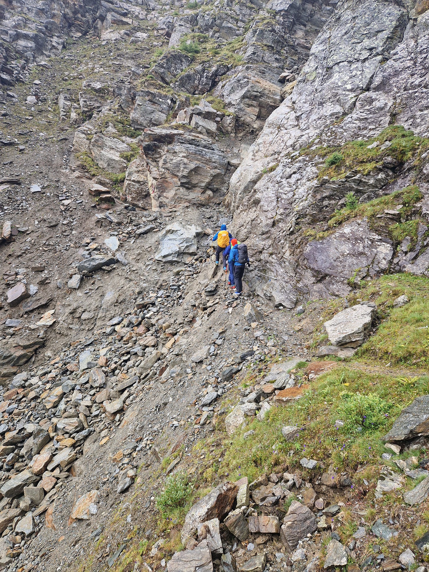 Walkers on a very narrow path over rockfall. Walkers on a very narrow path over rockfall.