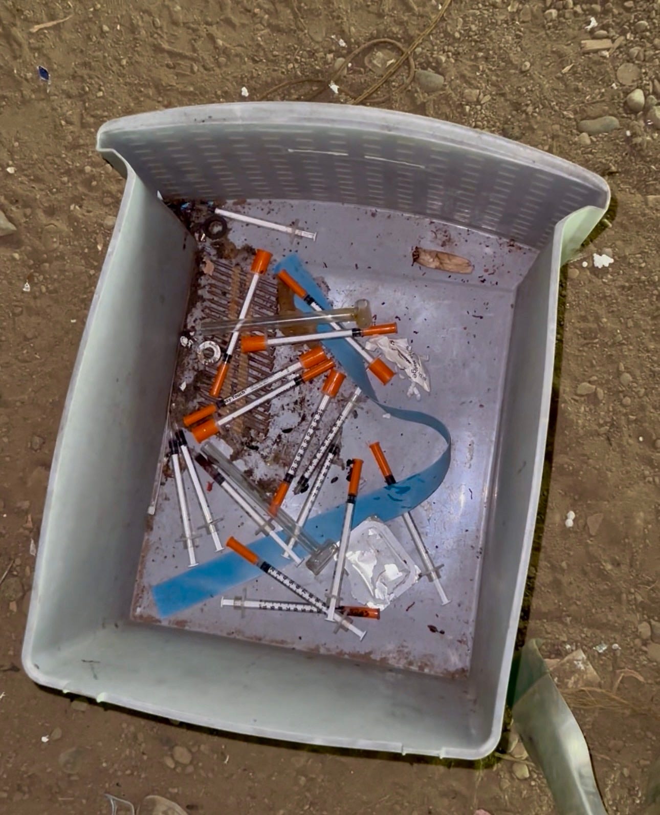 A trash can full of syringes
Description automatically generated A trash can full of syringes
Description automatically generated