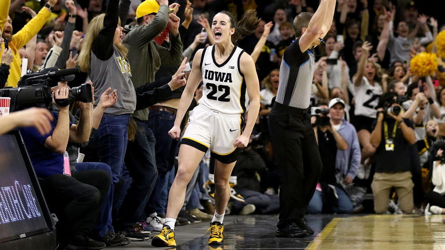 IOWA CITY, IOWA- FEBRUARY 15: Guard Caitlin Clark #22 of the Iowa Hawkeyes celebrates after breaking the NCAA women's all-time scoring record during the first half against the Michigan Wolverines at Carver-Hawkeye Arena on February 15, 2024 in Iowa City, Iowa. (Photo by Matthew Holst/Getty Images) IOWA CITY, IOWA- FEBRUARY 15: Guard Caitlin Clark #22 of the Iowa Hawkeyes celebrates after breaking the NCAA women's all-time scoring record during the first half against the Michigan Wolverines at Carver-Hawkeye Arena on February 15, 2024 in Iowa City, Iowa. (Photo by Matthew Holst/Getty Images)