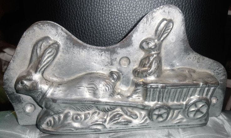 This may contain: a metal object that looks like a sleigh with rabbits in it on a blue cloth This may contain: a metal object that looks like a sleigh with rabbits in it on a blue cloth