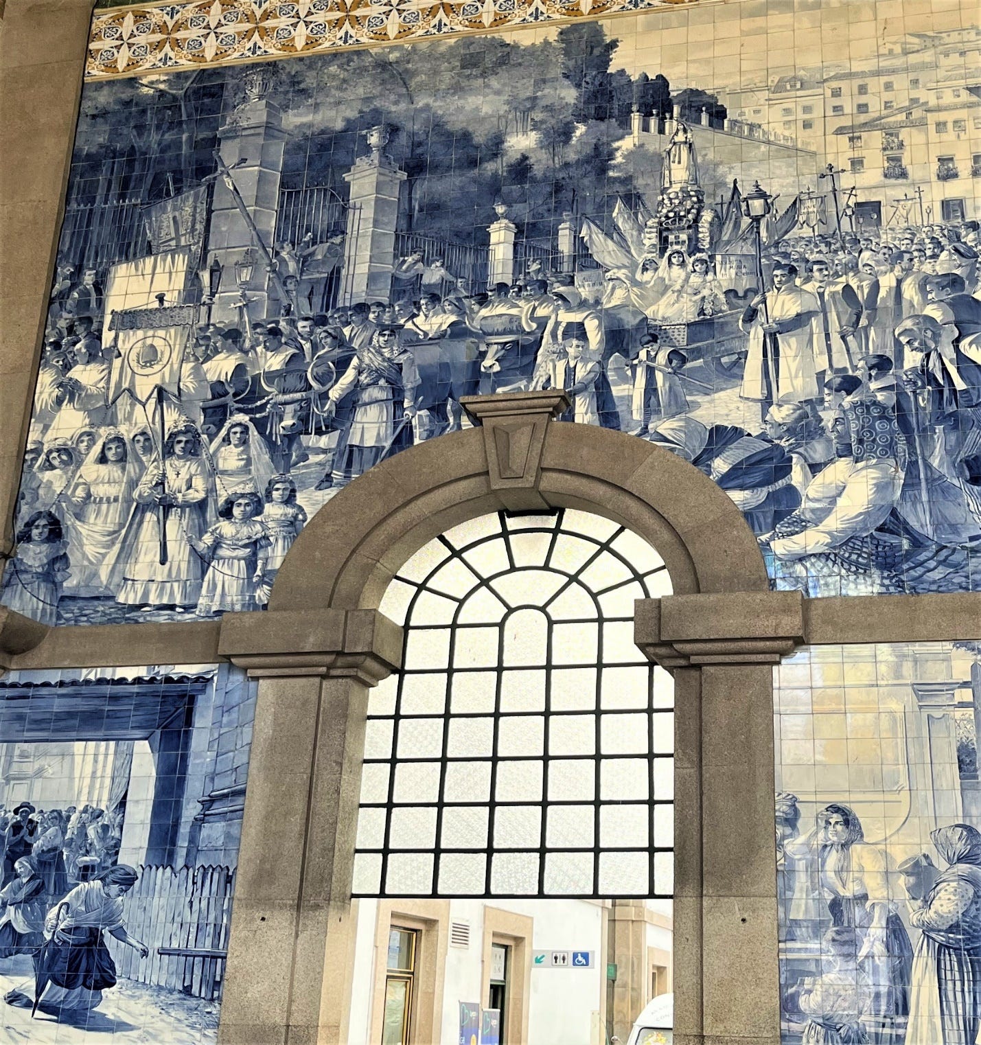 A blue and white tiled wall with a window

Description automatically generated