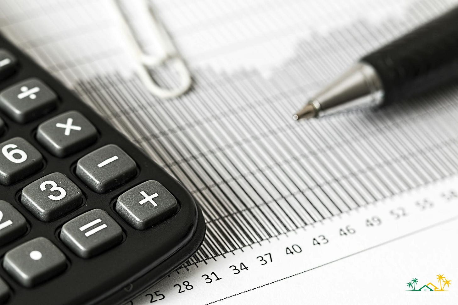 calculator and pen on table