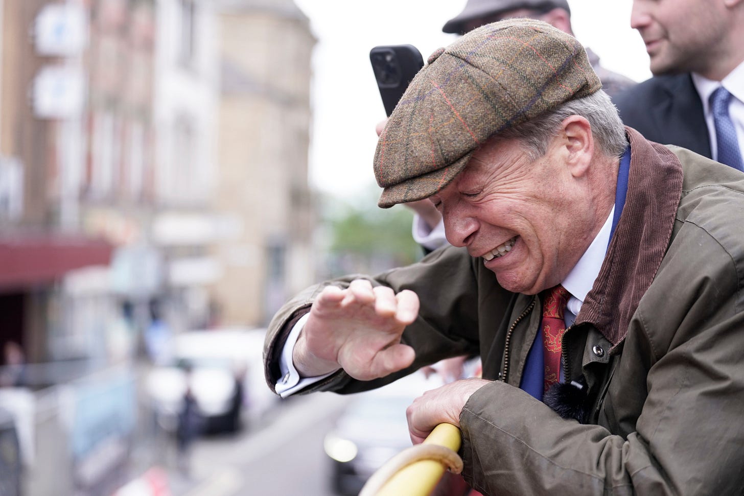 Nigel Farage has objects thrown at him from work site while on open top bus  | The Independent
