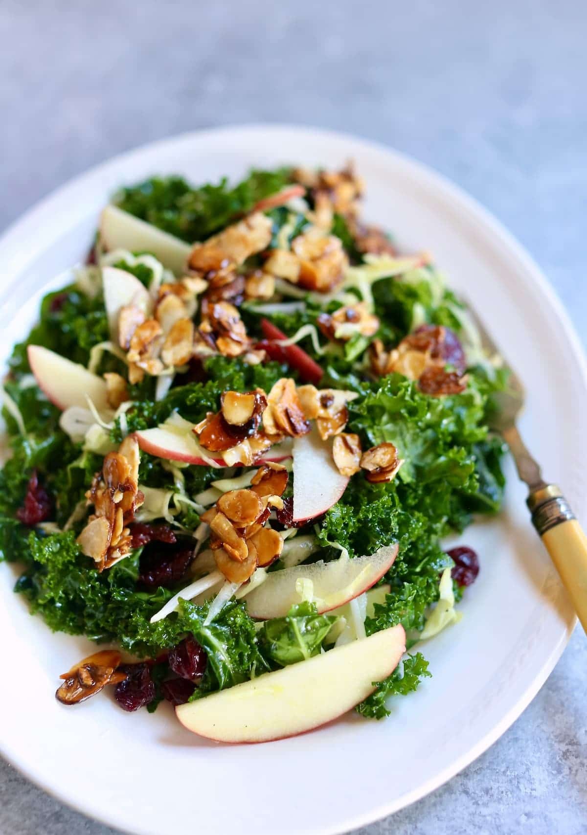 a white plate with a salad on it.