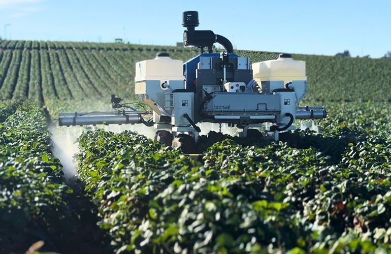 amiga flex in a field spraying crops.