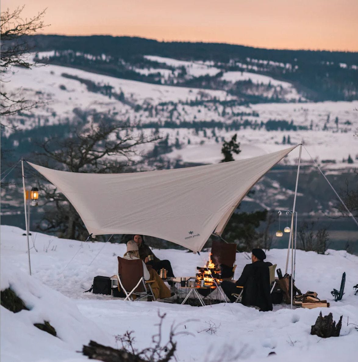 Winter camping setup surrounded by snow-covered landscapes Winter camping setup surrounded by snow-covered landscapes