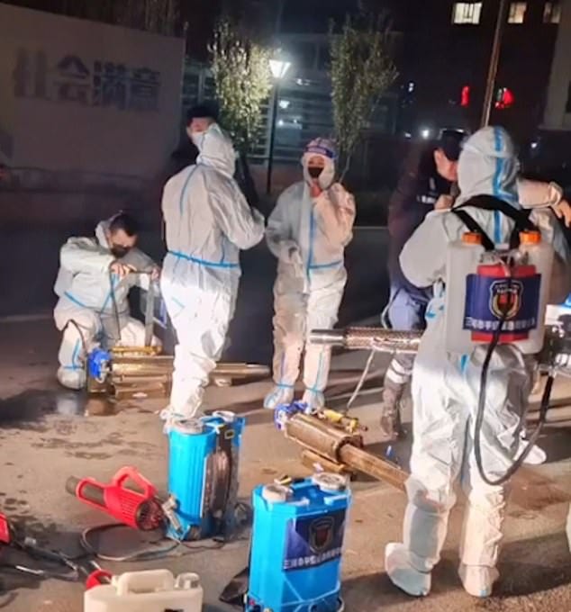 Footage has emerged of workers in Hazmat suits spraying classrooms allegedly in the city of Sanhe, about 40 miles east of Beijing. It was posted by activists based in New York who said the footage was recent Footage has emerged of workers in Hazmat suits spraying classrooms allegedly in the city of Sanhe, about 40 miles east of Beijing. It was posted by activists based in New York who said the footage was recent