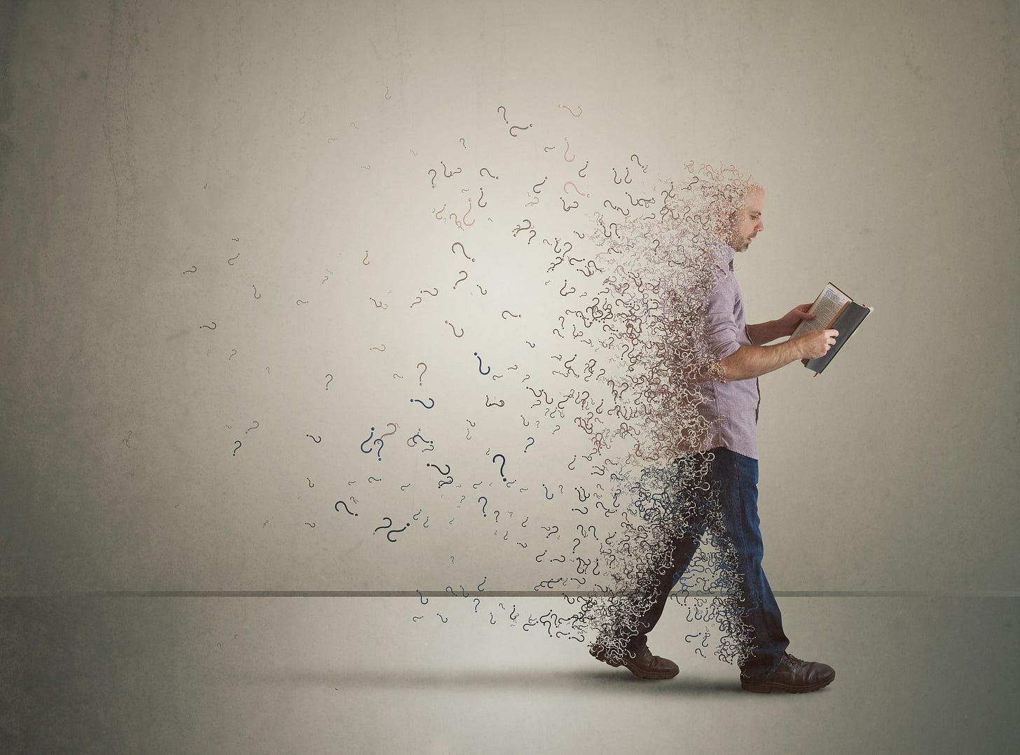 A man walking forward while fragments and question marks dissolve from his body behind him. A man walking forward while fragments and question marks dissolve from his body behind him.