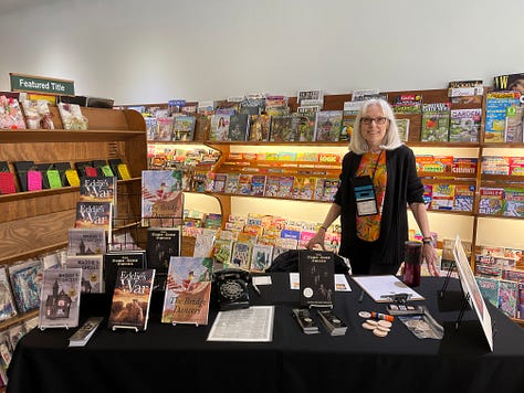 Photos of an auditorium of students, a line of students gaving books signed, and Carol behind a table at Wordsmith Bookshoppe in Knoxville IL