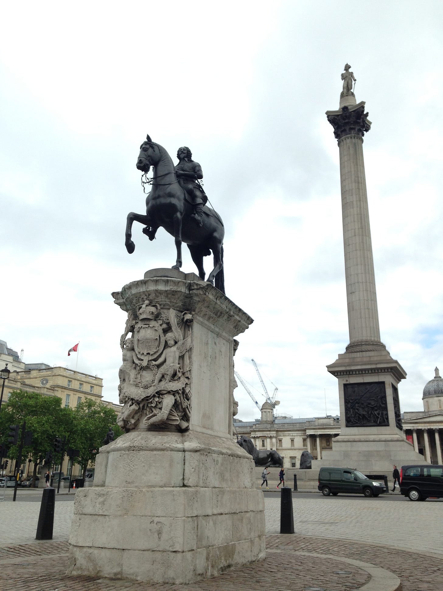 Photograph of the statue of Charles I in Trafalgar Square, an equestrian statue on a tall and ornate stone plinth. Nelson's Column can be seen behind it. Photograph of the statue of Charles I in Trafalgar Square, an equestrian statue on a tall and ornate stone plinth. Nelson's Column can be seen behind it.