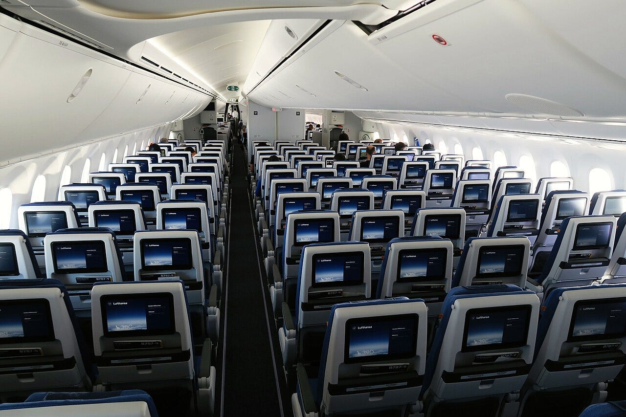 Photo: Cityswift / Wikimedia Commons (CC BY 2.0) Willkommen - welcome to Lufthansa 787 economy. The view from the rear of the dreamliner, most of this section was not occupied due to capped capacity on these crew training flights. The economy cabin is fitted with Recaro seating arranged in a 3-3-3