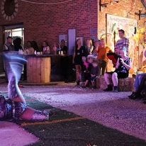 May be an image of 9 people, people standing, outdoors and brick wall