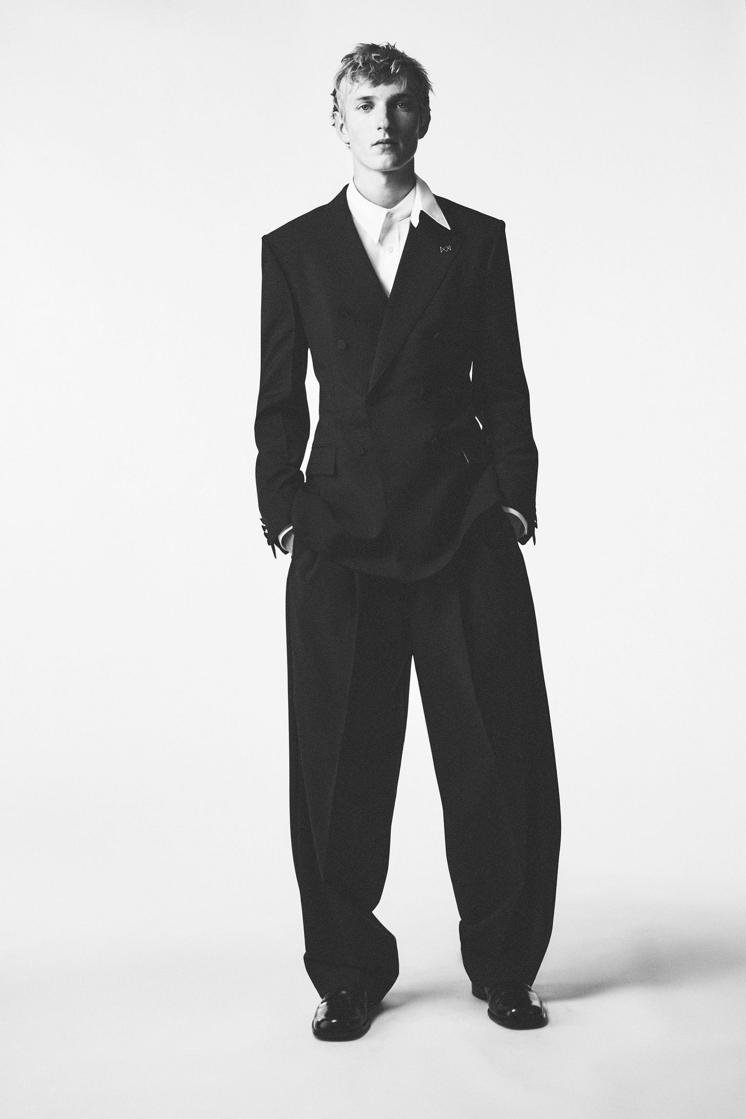 Image may contain Clothing Formal Wear Suit Tuxedo Coat Adult Person Face and Head