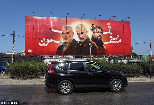 A car drives past a poster depicting late Hamas leader Ismail Haniyeh, top commander of Iran's Quds Force Qassem Soleimani and Hezbollah top commander Fuad Shukr in Beirut, Lebanon