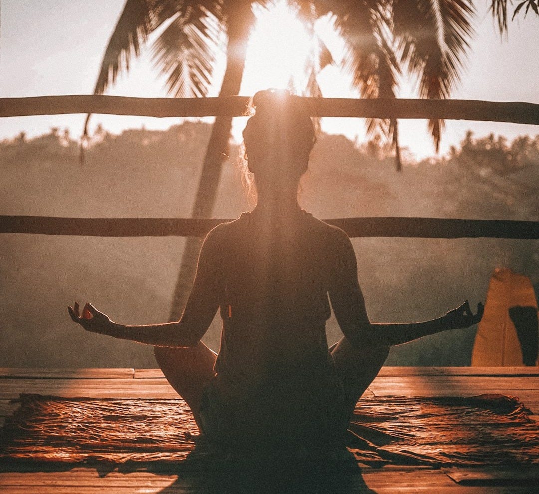 woman doing yoga meditation on brown parquet flooring woman doing yoga meditation on brown parquet flooring