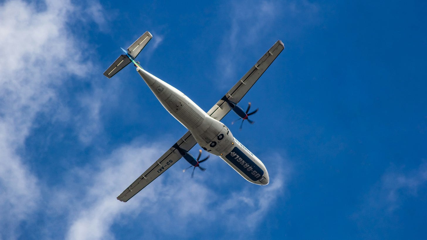 A large airplane soaring through a clear blue sky, representing advancements in eVTOL aircraft technology.