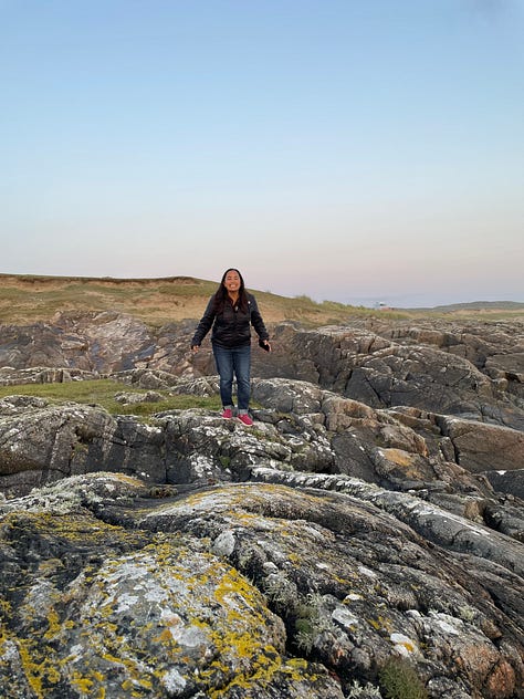 image one is my feet soaking in a tub filled with kelp. Image two is a beautiful Celtic fireplace fueled by peat moss. Image three is a woman standing joyfully along the cliffs on Cleggan
