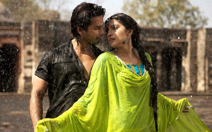 This may contain: a man and woman are dancing in the rain