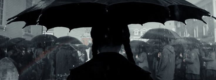 This may contain: people are standing in the rain with umbrellas over their heads and one person is holding an umbrella