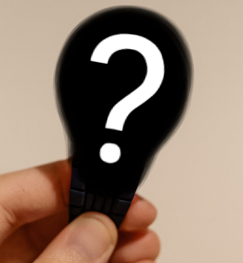 Hand holding a blurred-out wristwatch with a large white question mark, symbolizing a mystery design.