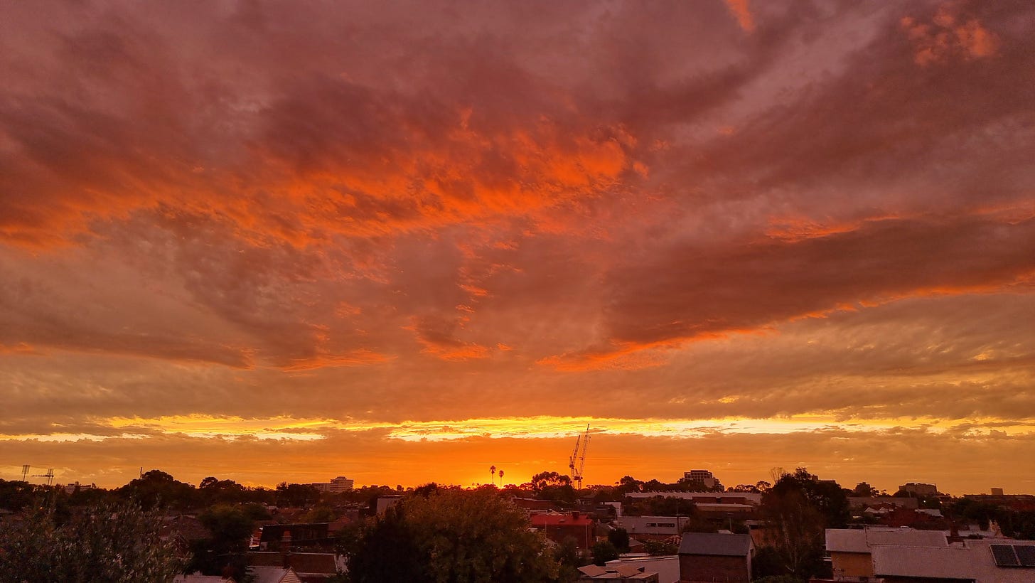 A fiery red cloudy sky at sunset. The sun has gone, but the colour is still all there, reflecting the heat of the day.