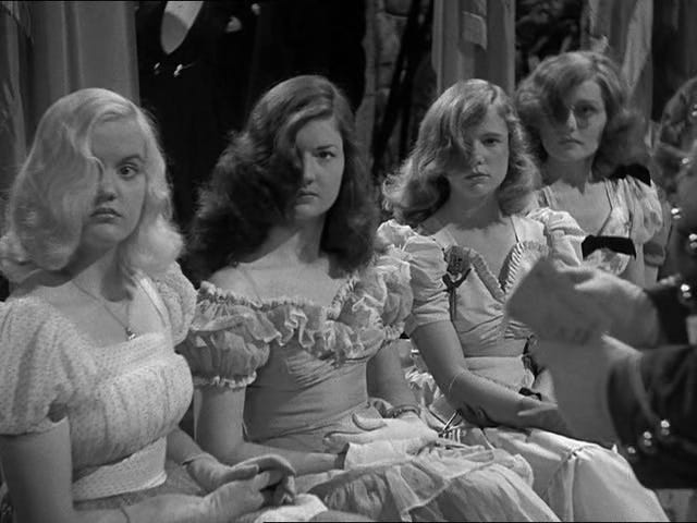 Four young women dressed glamourously and sporting similar hair-over-one-eye haircuts Four young women dressed glamourously and sporting similar hair-over-one-eye haircuts