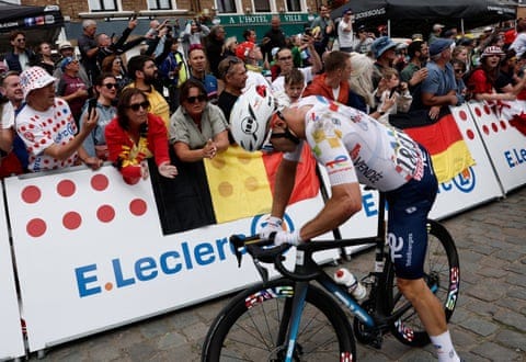 TotalEnergies' Matteo Vercher gets back on his bike after colliding with Cofidis' Benjamin Thomas during stage one of the Tour de France 2025.
