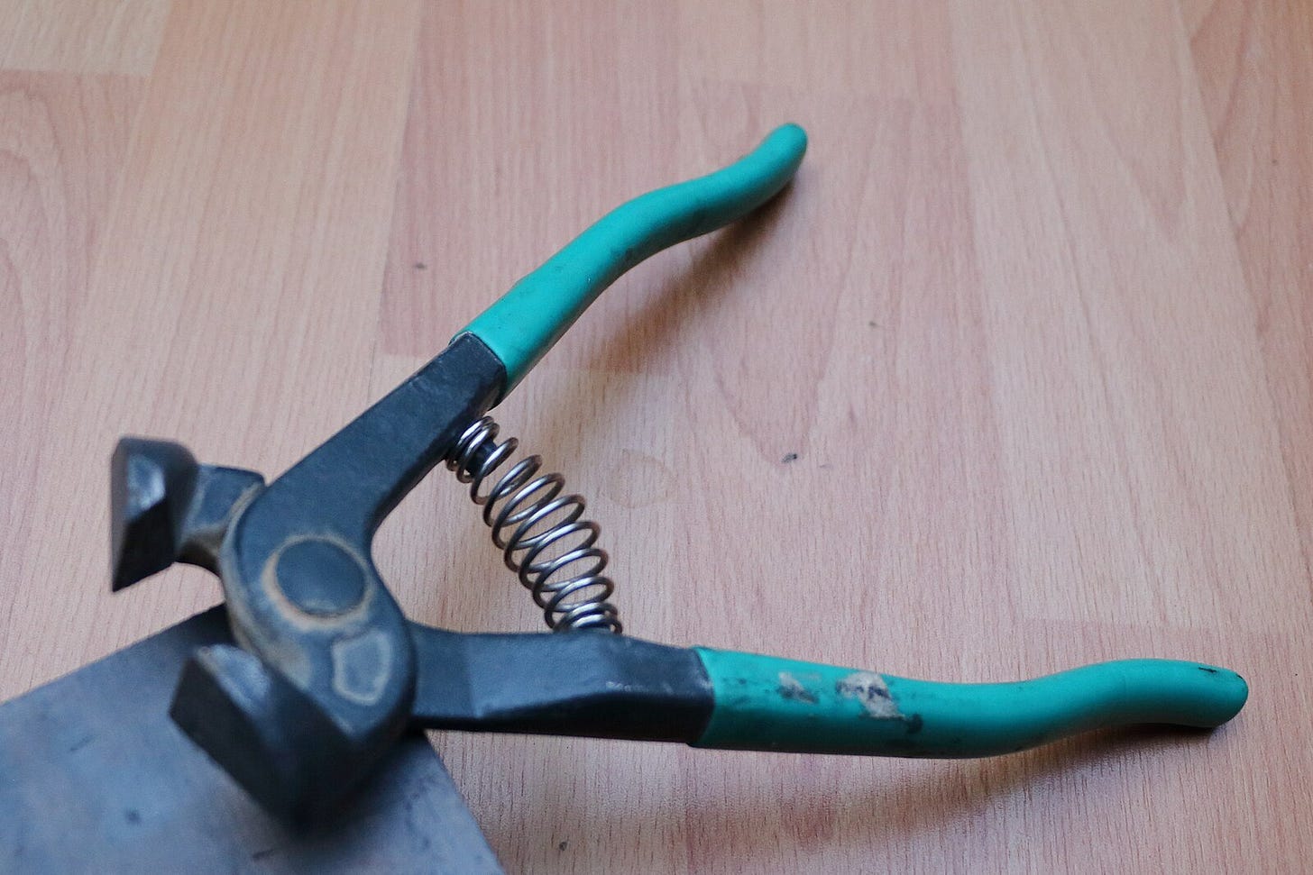 a picture of black mosaic nippers with turquoise arms