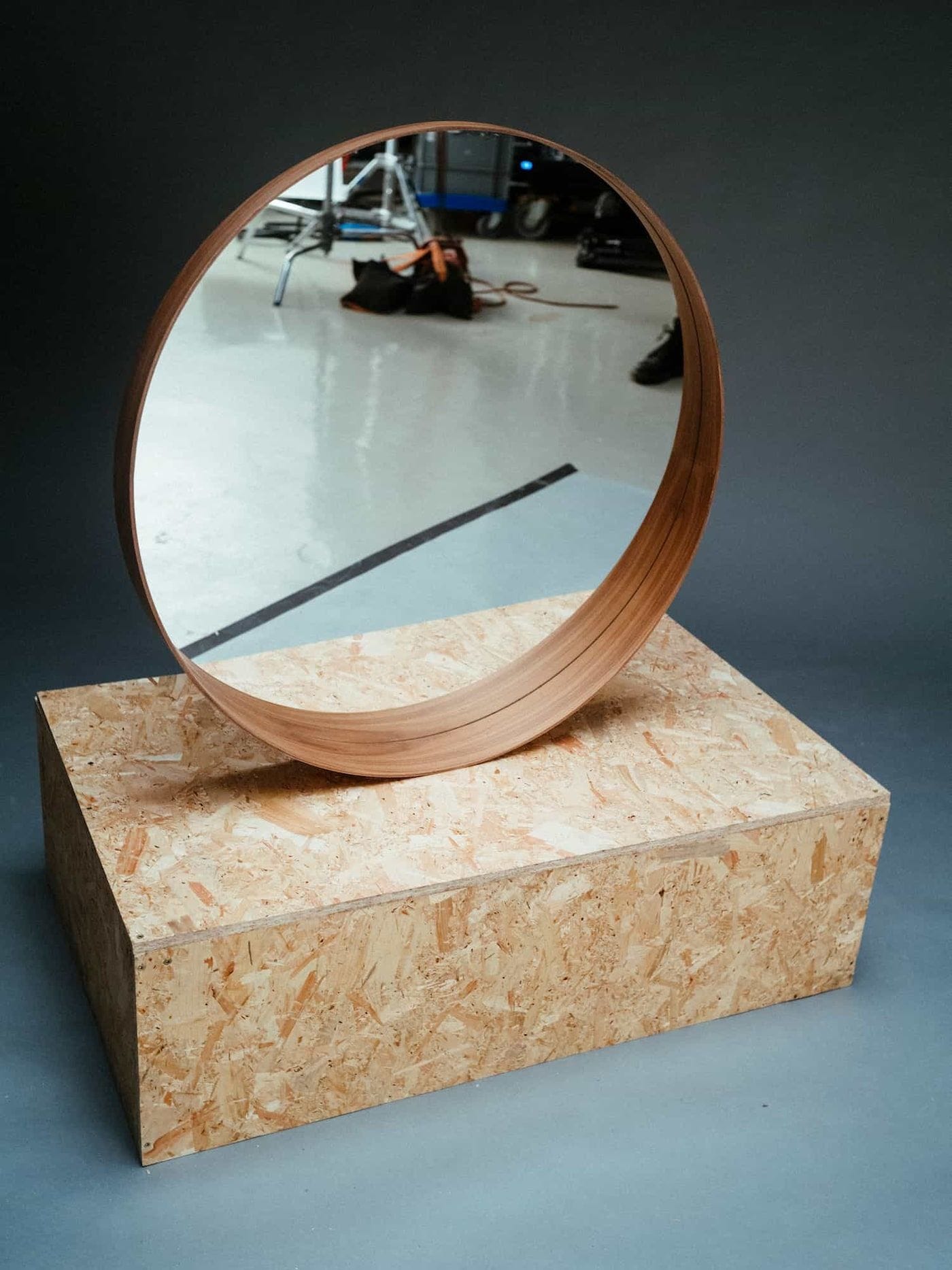 Restored IKEA STOCKHOLM mirror displayed on a chipboard podium.