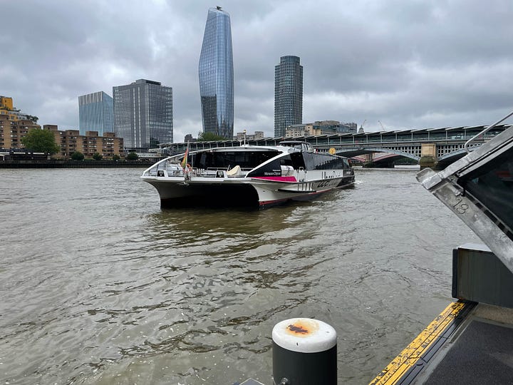 The first image is of a cycle hire docking station with bicycles in London. The second is of the entrance to the Greenwich Foot Tunnel on the Isle of Dogs. The third is of the Thames River Boat service approaching Blackfriars Pier. The fourth is of a South Eastern rail service at Maze Hill station, with the foot bridge in the background