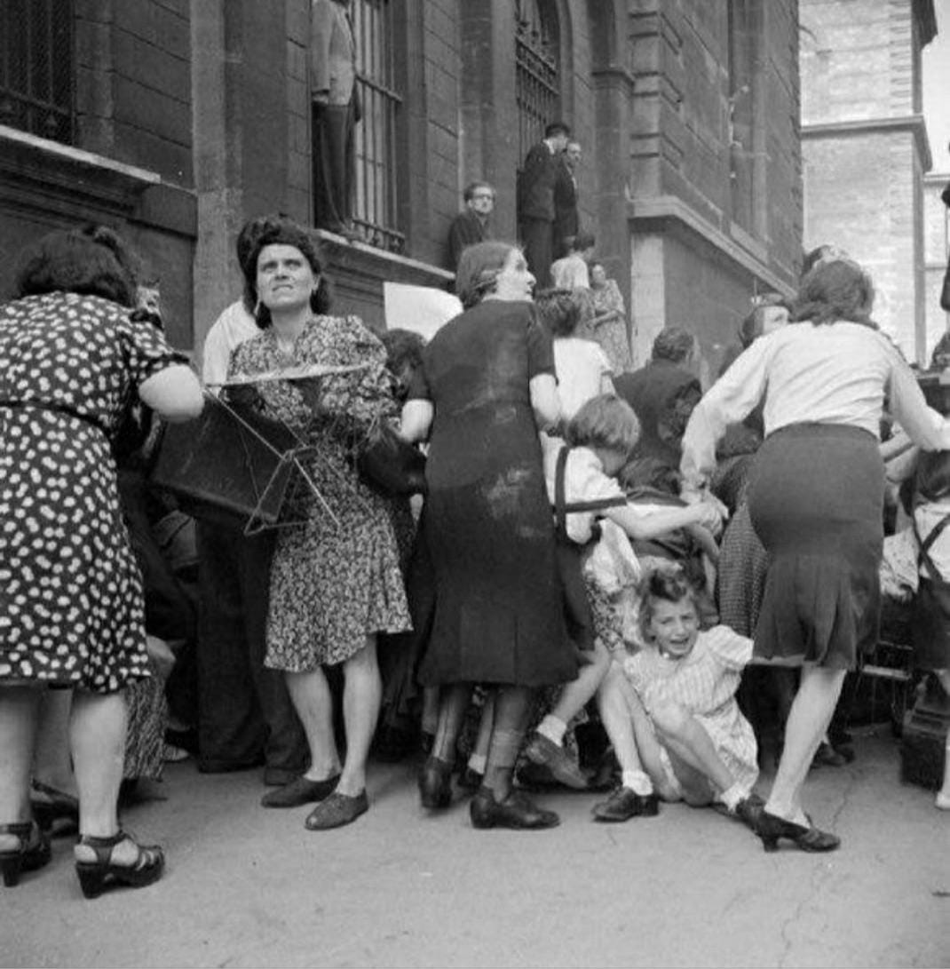 Parisian mothers cover their children from German snipers 1944