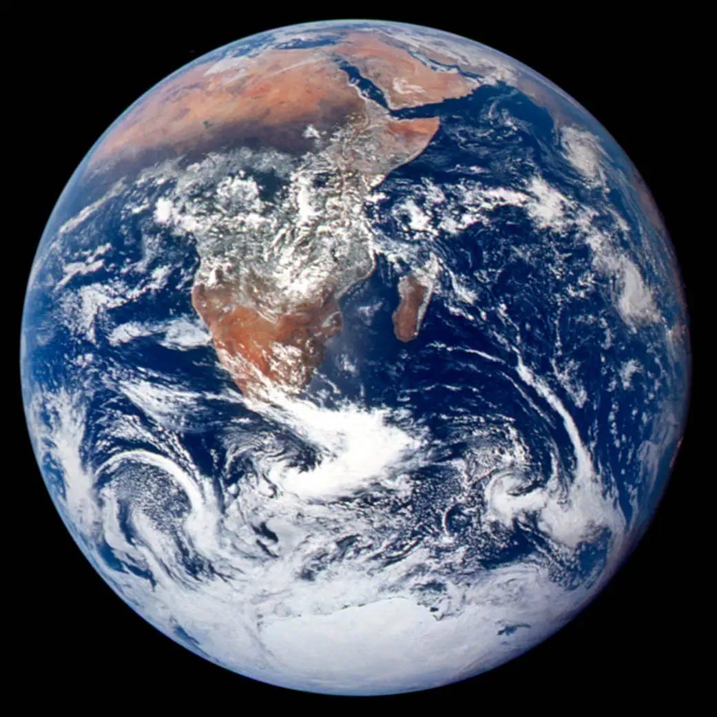 A view of Earth from space, showcasing Africa's diverse landscapes and the vibrant blue oceans surrounded by swirling clouds.