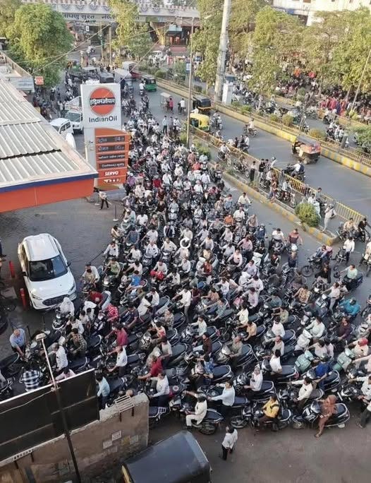 May be an image of one or more people, motorcycle, crowd and text