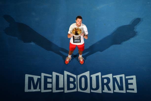 Switzerland's Stanislas Wawrinka poses with the trophy after victory in his mens singles final match against Spain's Rafael Nadal on day fourteen of...