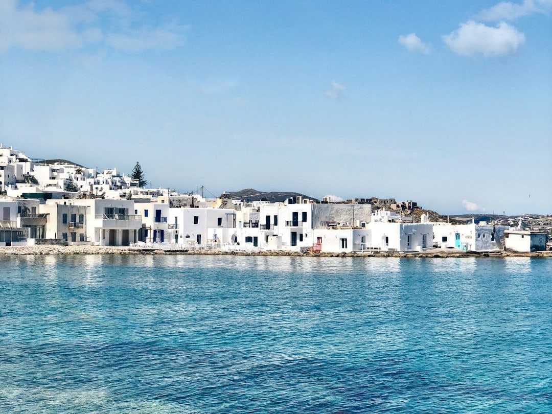 white concrete building beside body of water during daytime