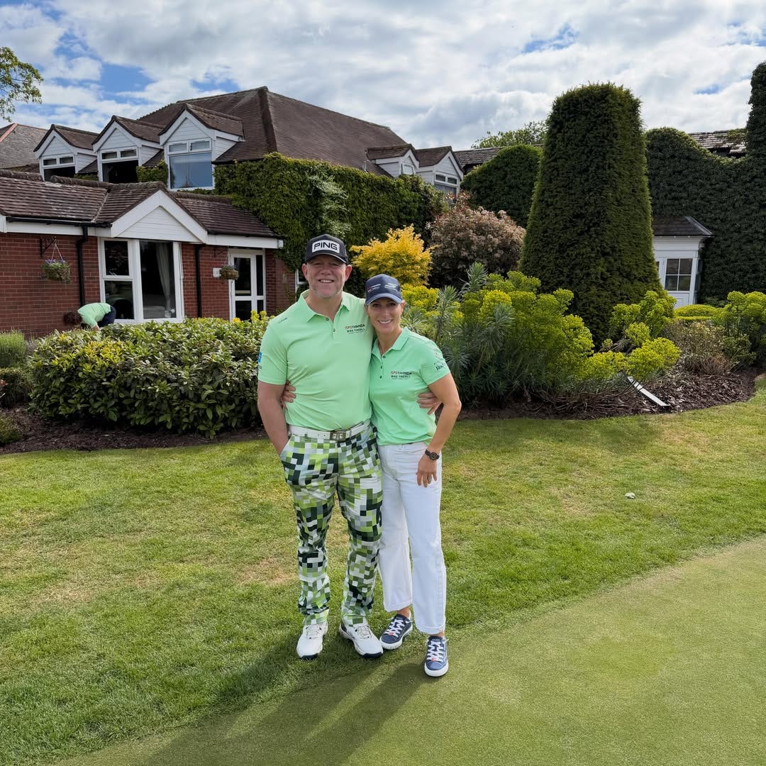 Mike and Zara Tindall with their arms round each other in the garden wearing green outfits