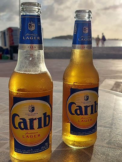 2 Carib Beers on a table at sunset, Sint Maarten, Caribbean
