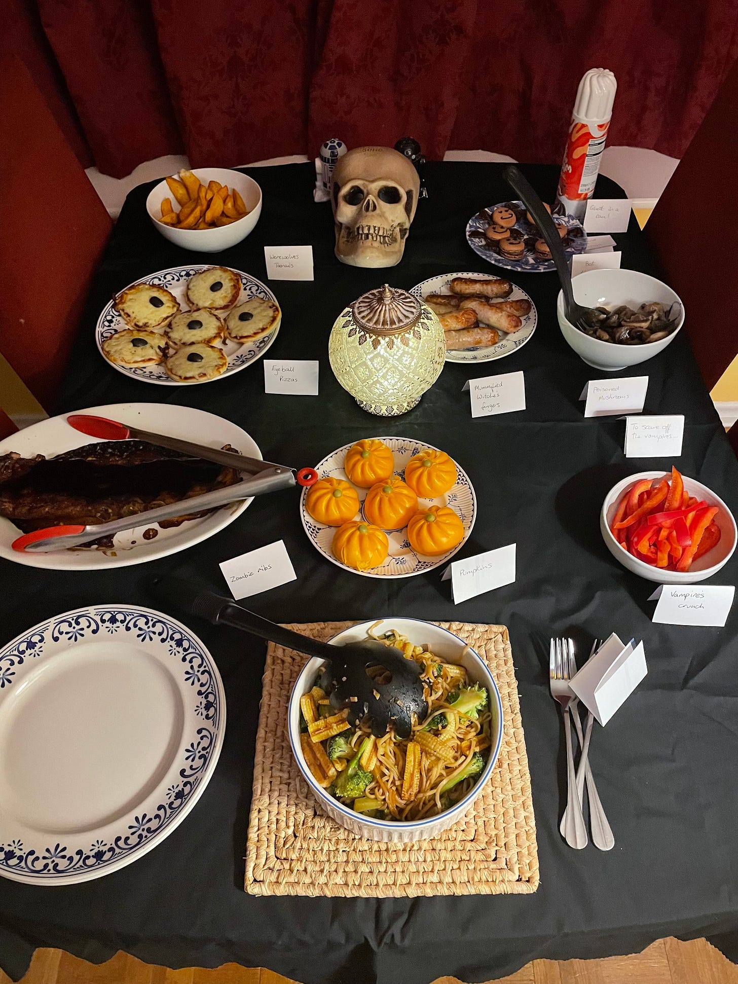 A table with halloween decorations and themed food
