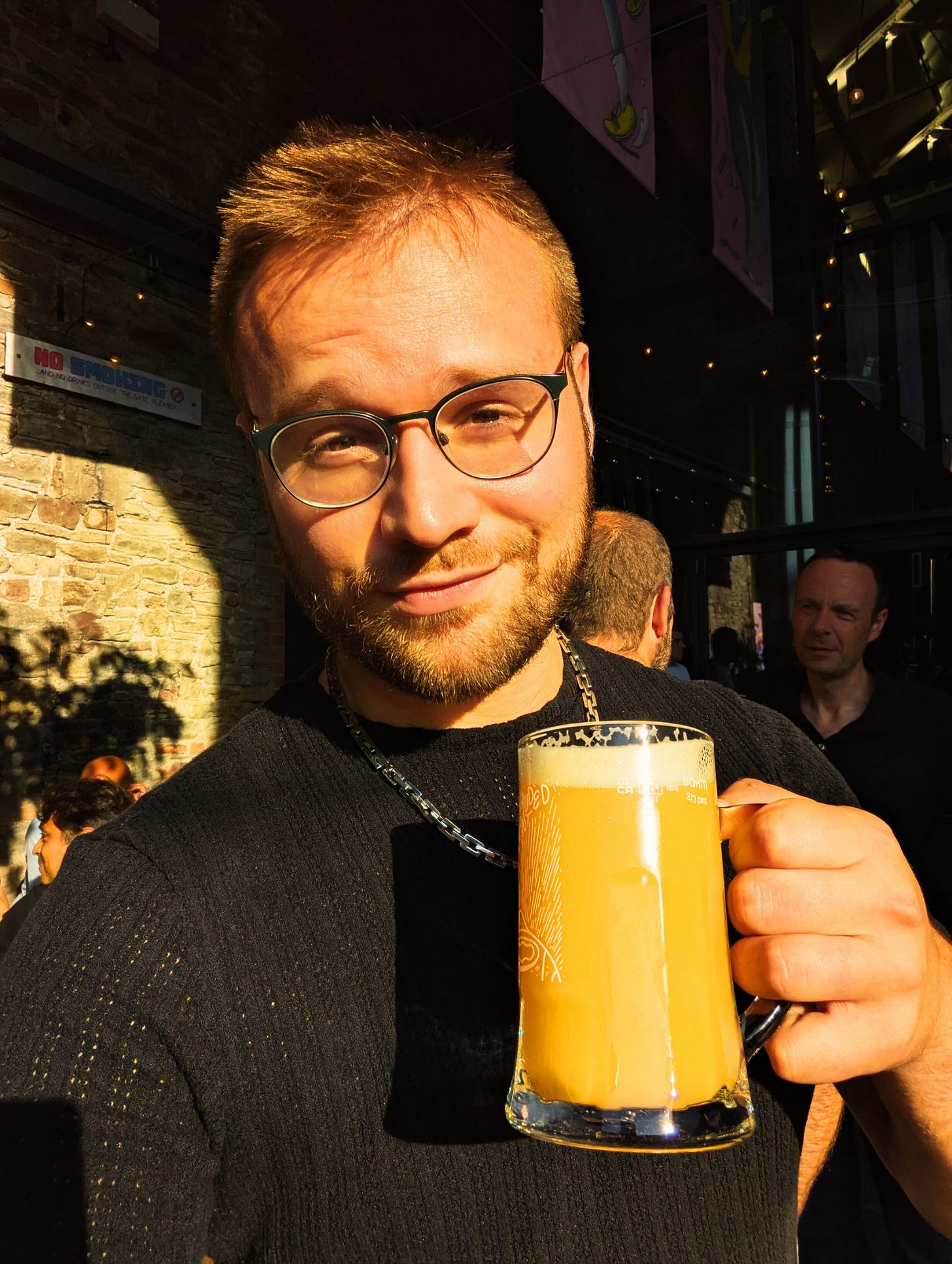 Author Stuart Found writer of Never Lost Letters raising a beer in a beer garden in summer 2025