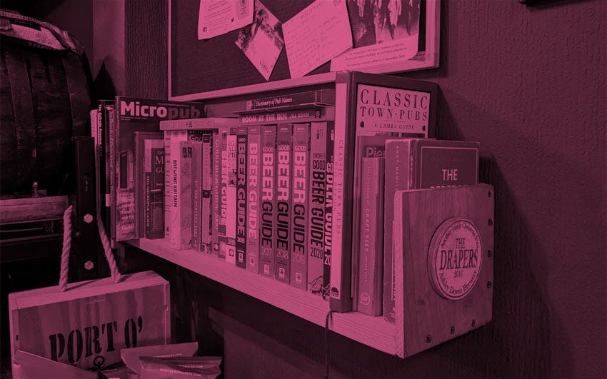 A selection of pub guides on a pub shelf.