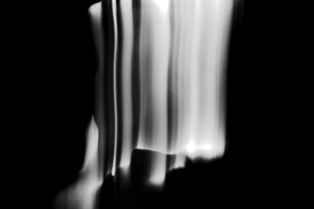 a blurry photo of a tall building in the dark