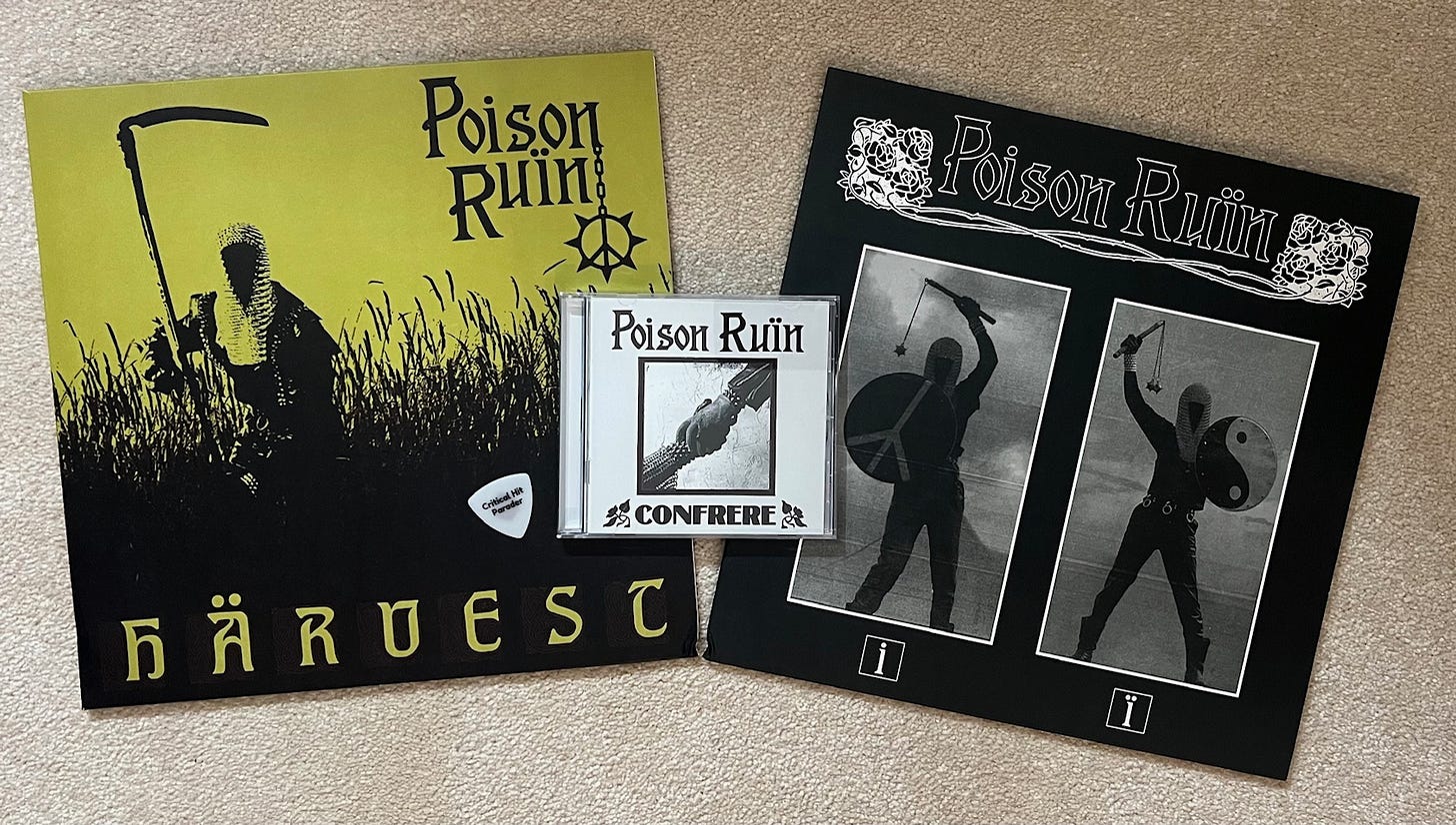 Two vinyl albums by the band Poison Ruin. The first is called Harvest and is green and black with  scythe wielding figure in a chainmail hood in a field. The second is self titled and features black and white flail and shield wielding figures. On top of the albums is the CD for Poison Ruin's Confrere that is black and white and shows two shaking hands, one of which is chainmail clad. Umlauts are liberally used on all three pieces of media. A white Critical Hit Parader guitar pick sits stoically on the first album.