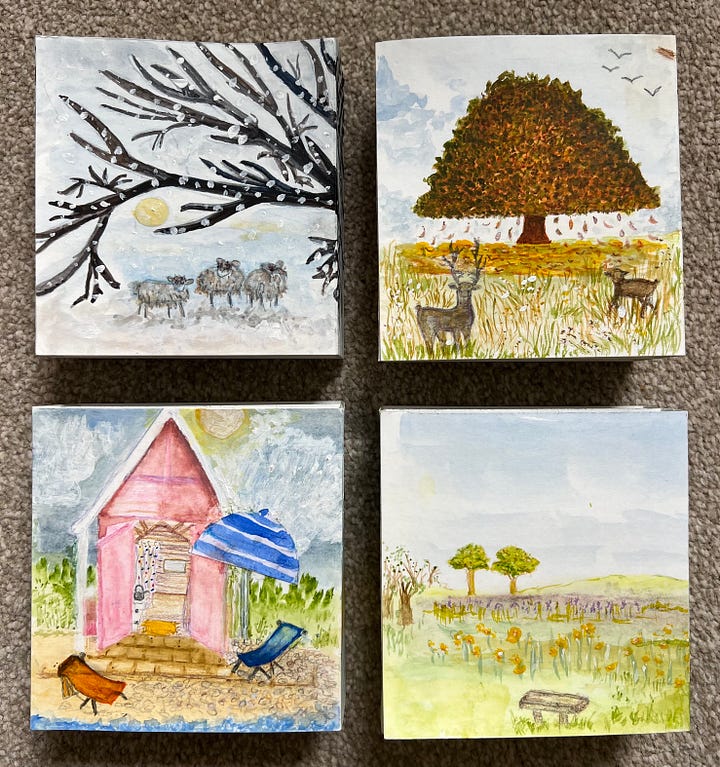 A collection of paper tunnel books handmade depicting the four season illustrated in watercolour and ink