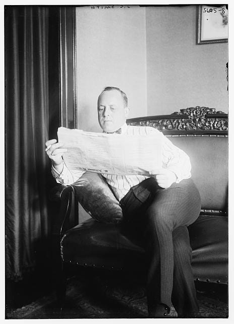 a black and white photo of a man reading the newspaper a black and white photo of a man reading the newspaper