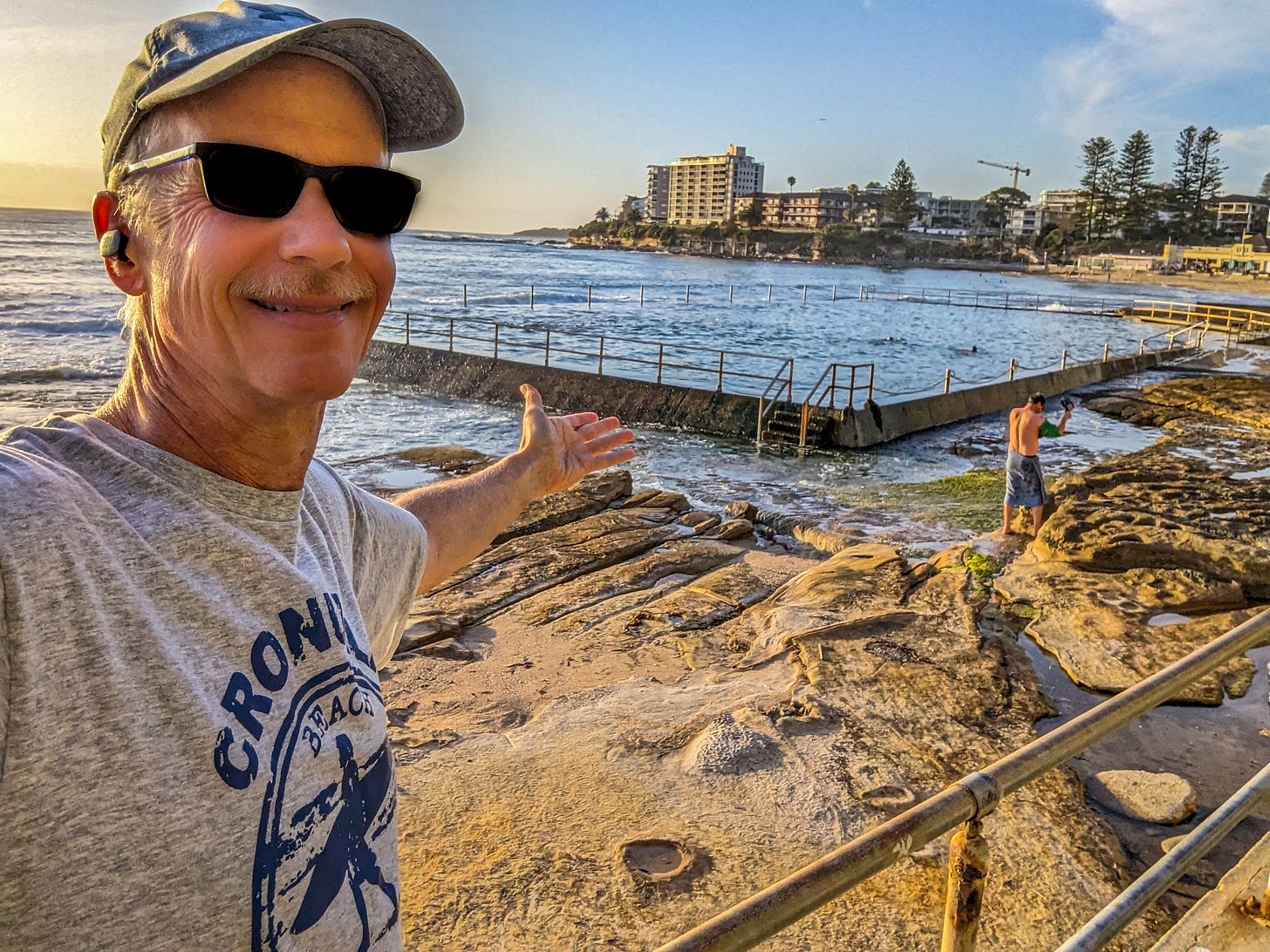 Michael gesturing at the rock pool behind him. 