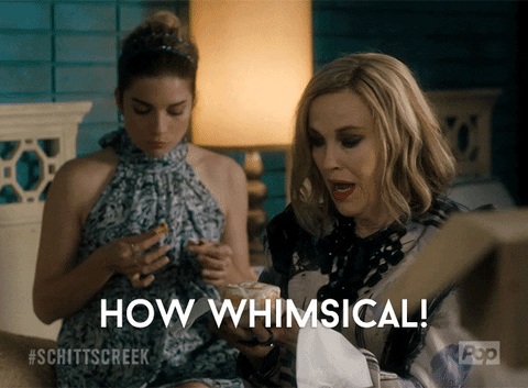 A gif of Moira Rose from Schitt's Creek holding a glazed donut and saying "How whimsical!"
