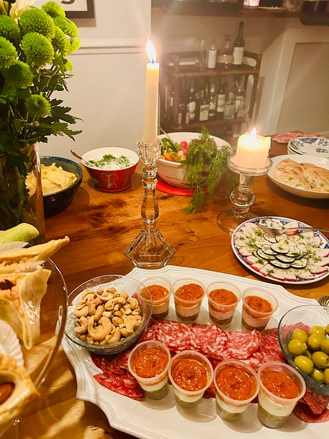bottles of French wine from two tastings. Wines of Burgundy and the Loire Valley. Plates of appetizers on a wooden table.