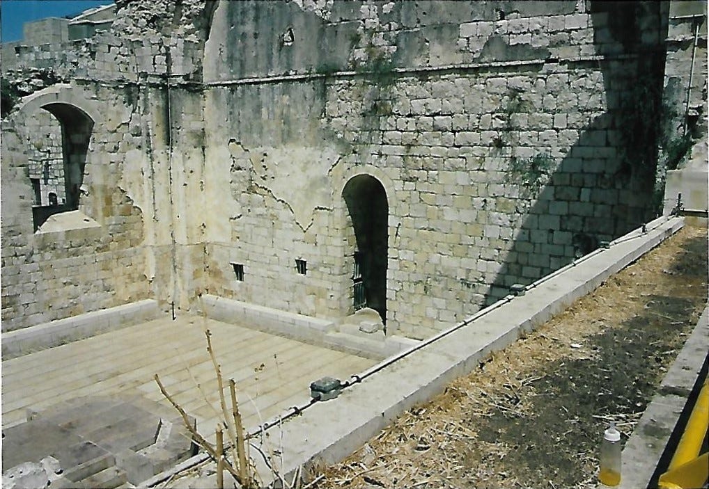 Two ruined walls and a reconstructed floor in Israel