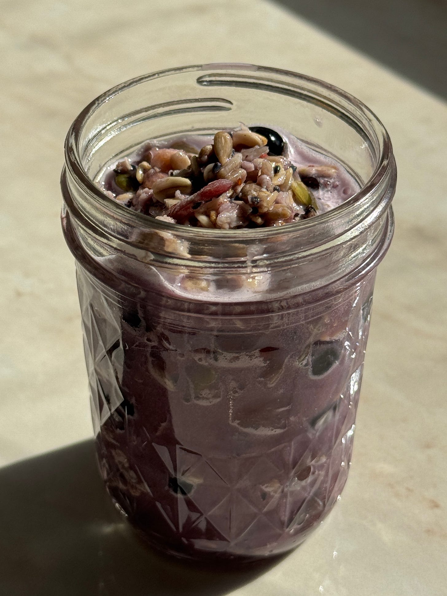 Triple berry overnight oats made with raspberries, blueberries, blackberries, banana, rolled oats, and seeds