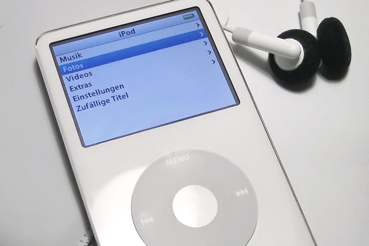A 5th gen iPod Classic with wired earbuds. A 5th gen iPod Classic with wired earbuds.